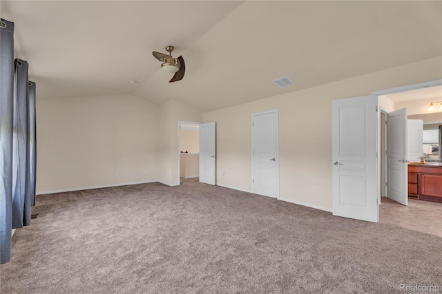 6119 Amber Ln, Grand Blanc, MI 48439 - unfurnished bedroom with light colored carpet, lofted ceiling, ensuite bathroom, and ceiling fan