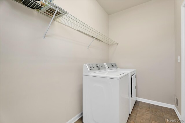 6119 Amber Ln, Grand Blanc, MI 48439 - laundry room with separate washer and dryer and baseboards