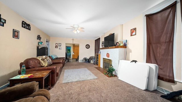 405 W 5th St, Evart, MI 49631 - carpeted living room featuring a brick fireplace and a ceiling fan