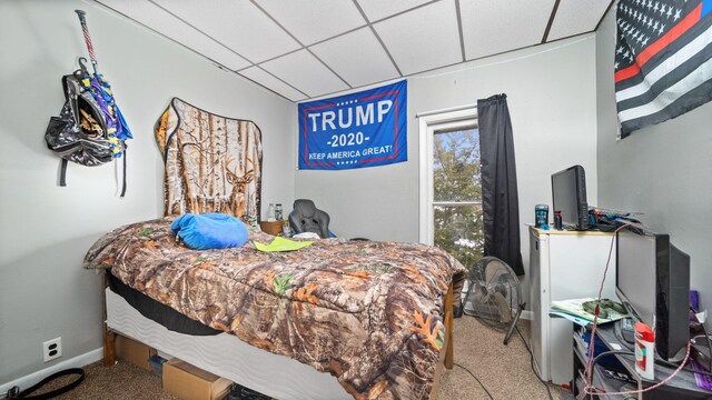 405 W 5th St, Evart, MI 49631 - carpeted bedroom featuring a drop ceiling and baseboards