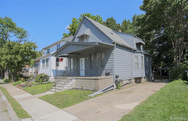 15251 Maplewood Ave, Eastpointe, MI 48021 - view of front of home featuring a front lawn, covered porch, and a shingled roof