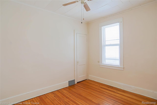 15251 Maplewood Ave, Eastpointe, MI 48021 - empty room featuring light wood-type flooring, healthy amount of natural light, ceiling fan, and crown molding