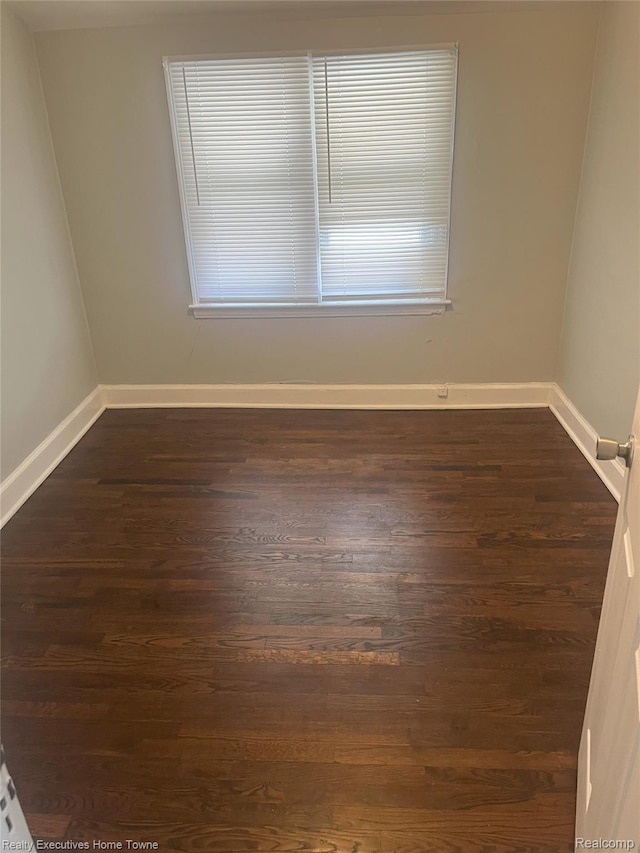 15251 Maplewood Ave, Eastpointe, MI 48021 - spare room featuring dark wood-type flooring and baseboards