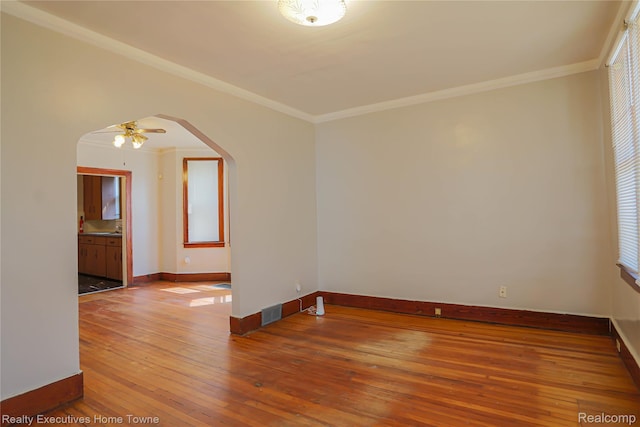 15251 Maplewood Ave, Eastpointe, MI 48021 - unfurnished room featuring arched walkways, hardwood / wood-style floors, ornamental molding, and ceiling fan