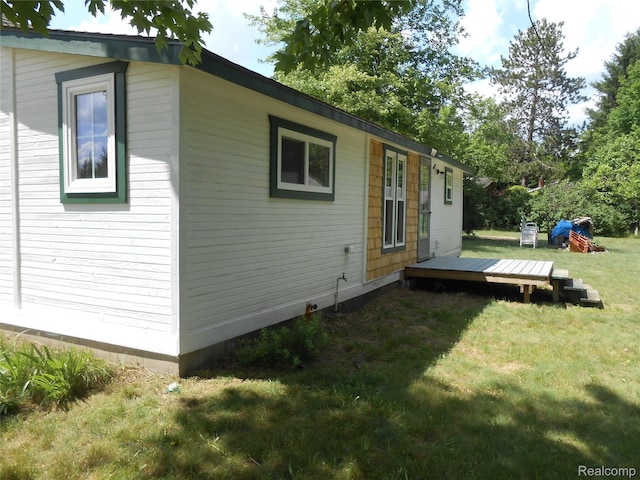 8027 Lakeshore Rd, Lexington, MI 48450 - back of house with a wooden deck and a lawn