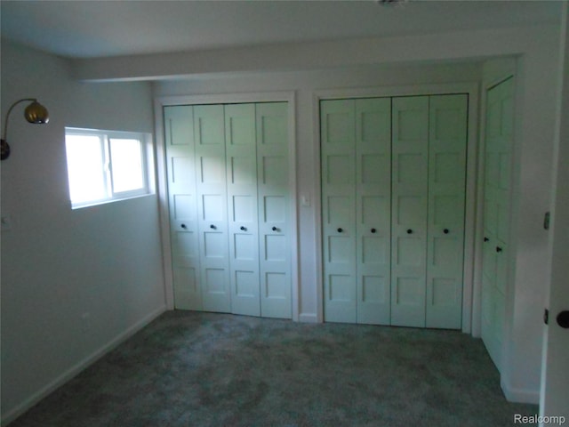 8027 Lakeshore Rd, Lexington, MI 48450 - unfurnished bedroom featuring two closets and carpet