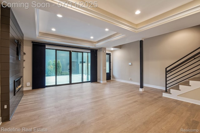 722 E Parent Ave, Royal Oak, MI 48067 - unfurnished living room featuring a raised ceiling, light wood-style floors, a fireplace, stairway, and recessed lighting