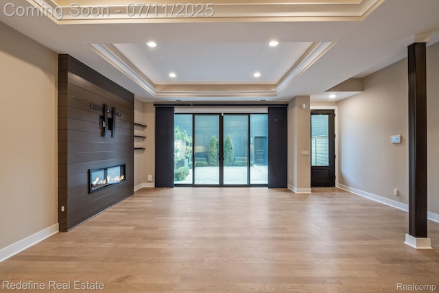 722 E Parent Ave, Royal Oak, MI 48067 - unfurnished living room with a raised ceiling, healthy amount of natural light, light wood-style floors, and recessed lighting
