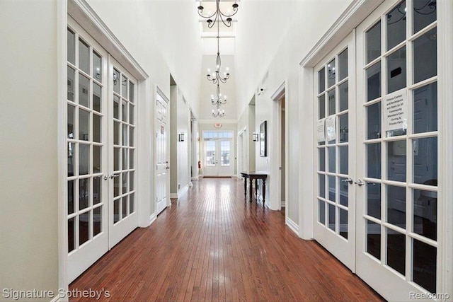 182 Amys Walk, Auburn Hills, MI 48326 - hall with french doors, a chandelier, wood finished floors, and a high ceiling