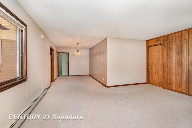 2936 Reppuhn Dr, Saginaw, MI 48603 - spare room featuring a baseboard heating unit, a chandelier, and light colored carpet