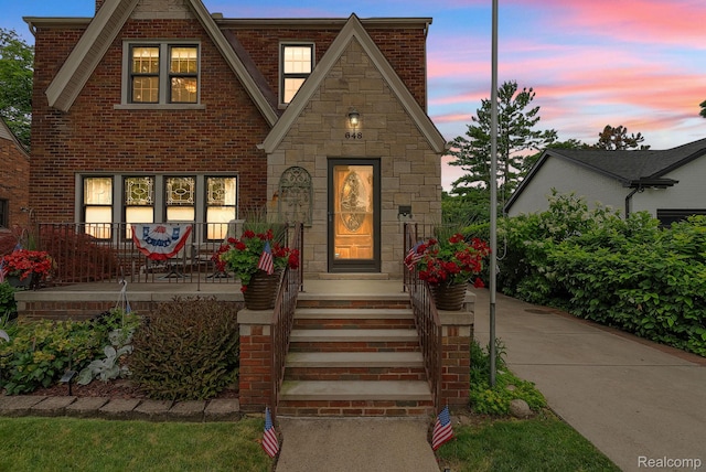 648 S Highland St, Dearborn, MI 48124 - tudor home with brick siding, covered porch, and stone siding