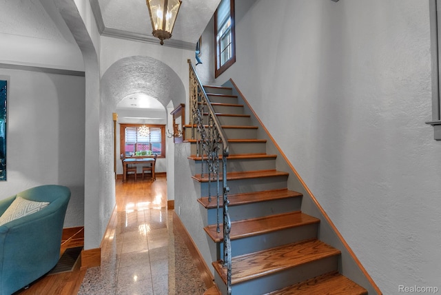 648 S Highland St, Dearborn, MI 48124 - staircase featuring a textured wall, arched walkways, granite floors, and a towering ceiling