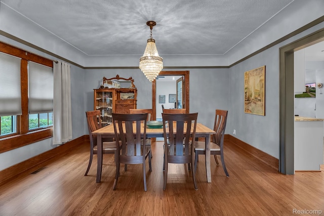 648 S Highland St, Dearborn, MI 48124 - dining room with wood finished floors and a chandelier