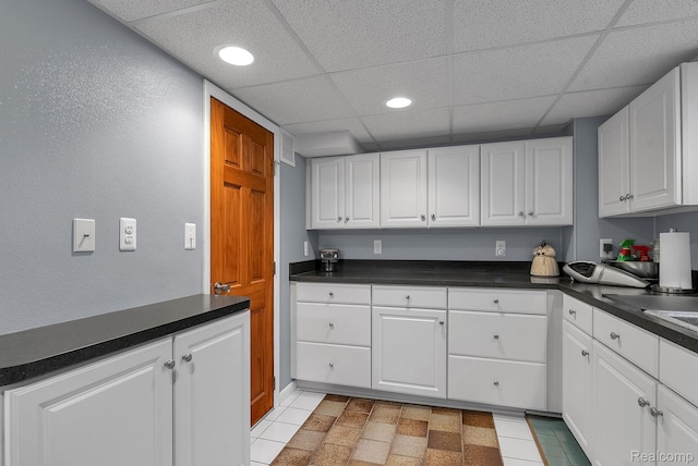 648 S Highland St, Dearborn, MI 48124 - kitchen featuring a drop ceiling, dark countertops, white cabinetry, and recessed lighting