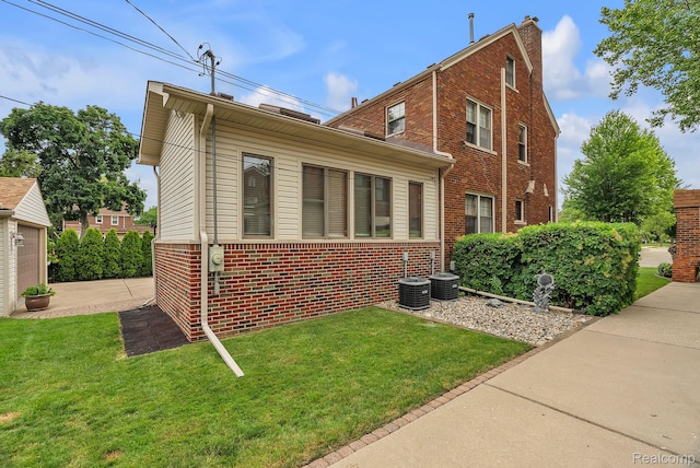 648 S Highland St, Dearborn, MI 48124 - view of side of property with brick siding, a lawn, and a chimney