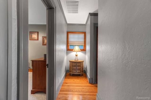 648 S Highland St, Dearborn, MI 48124 - corridor featuring light wood-type flooring, a textured wall, and crown molding