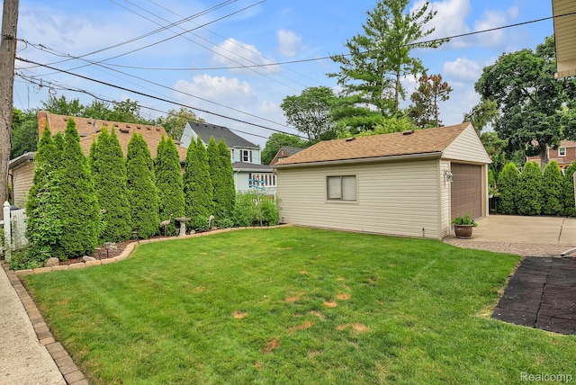 648 S Highland St, Dearborn, MI 48124 - view of grassy yard with an outdoor structure and a detached garage