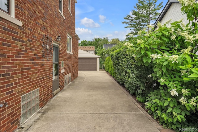 648 S Highland St, Dearborn, MI 48124 - view of side of property featuring brick siding, a detached garage, and an outdoor structure