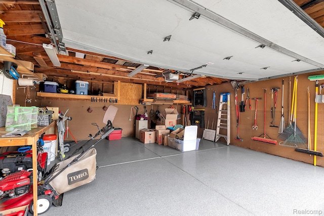648 S Highland St, Dearborn, MI 48124 - garage featuring a garage door opener and a workshop area