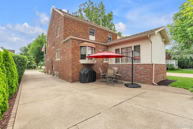 648 S Highland St, Dearborn, MI 48124 - back of house featuring brick siding and a patio area