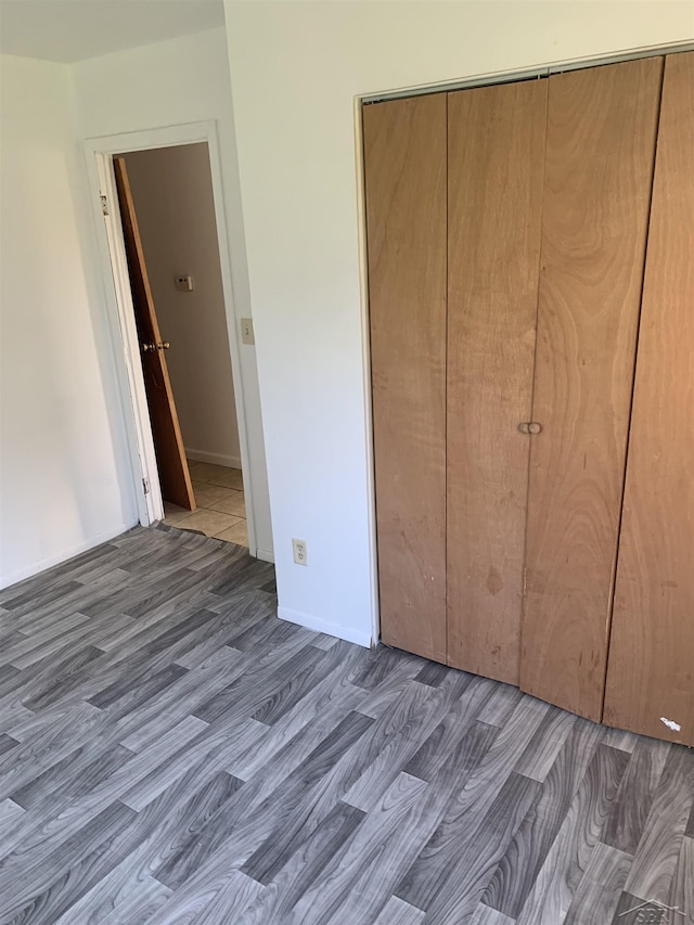 3308 Douglass St, Saginaw, MI 48601 - unfurnished bedroom featuring wood finished floors and a closet