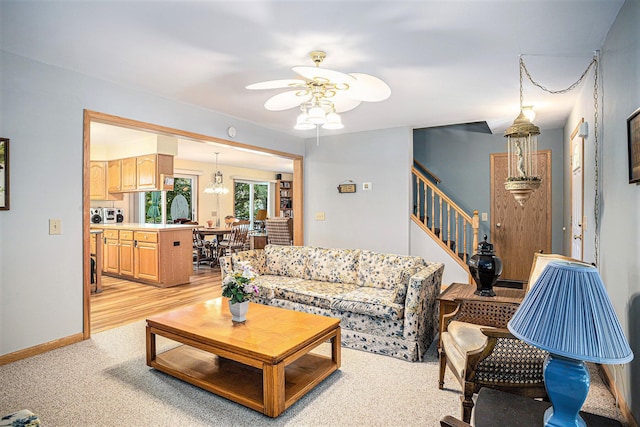 15891 Lakeview Dr, Buchanan, MI 49107 - living area with a ceiling fan, stairway, and a chandelier