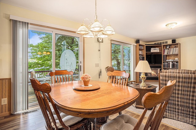 15891 Lakeview Dr, Buchanan, MI 49107 - dining room featuring a chandelier, wood finished floors, and a wainscoted wall