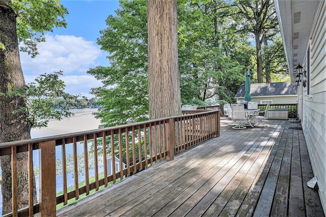 15891 Lakeview Dr, Buchanan, MI 49107 - wooden deck featuring outdoor dining area and a water view