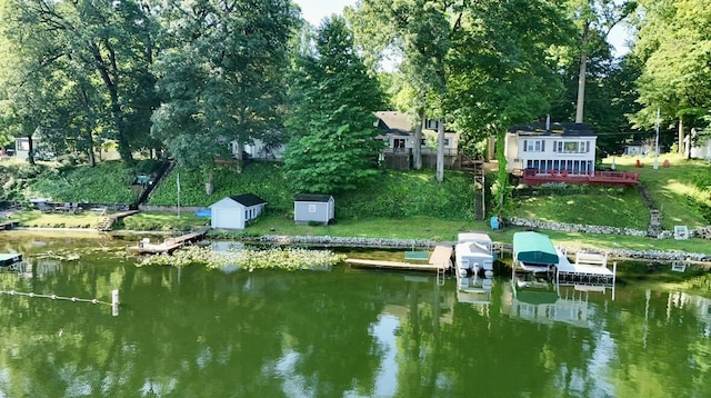 15891 Lakeview Dr, Buchanan, MI 49107 - dock featuring a water view, view of wooded area, boat lift, and a yard
