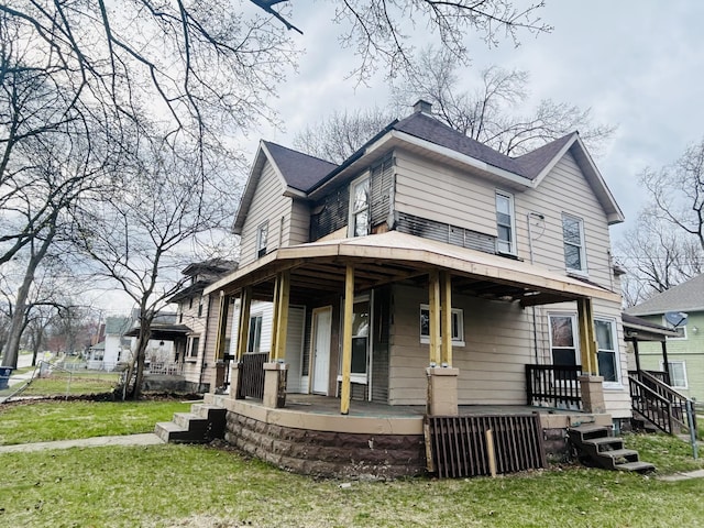 1520 E Ganson St, Jackson, MI 49202 - view of front of home featuring covered porch, a front yard, and a shingled roof