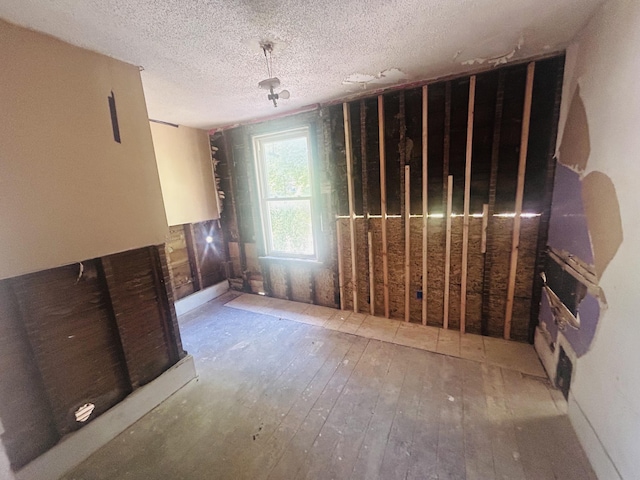1520 E Ganson St, Jackson, MI 49202 - misc room featuring hardwood / wood-style floors and a textured ceiling