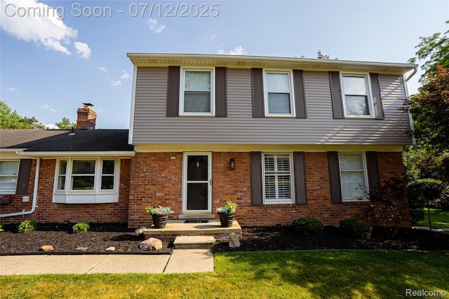 42331 Beacontree Ct, Northville, MI 48168 - colonial house featuring brick siding, a chimney, and a front lawn