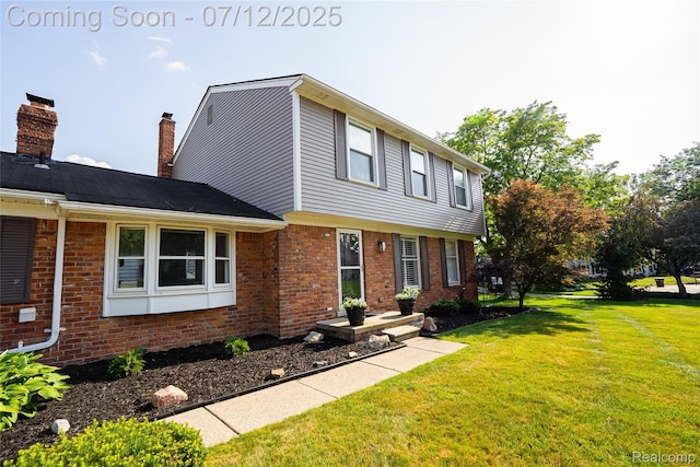 42331 Beacontree Ct, Northville, MI 48168 - colonial-style house with brick siding, a front lawn, and a chimney