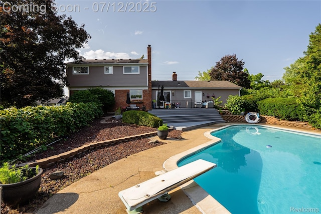 42331 Beacontree Ct, Northville, MI 48168 - outdoor pool featuring a diving board, a patio, and a wooden deck