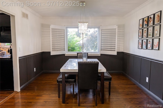 42331 Beacontree Ct, Northville, MI 48168 - dining space featuring wainscoting, ornamental molding, a chandelier, and dark wood-style flooring