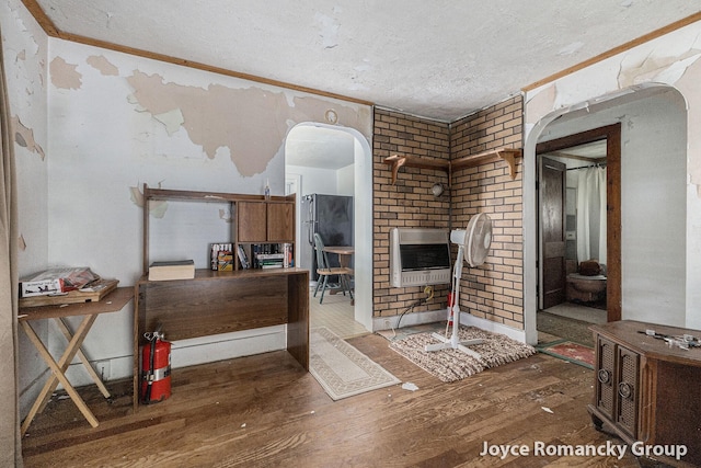 5752 E 52nd St, Newaygo, MI 49337 - living area featuring heating unit, wood finished floors, a textured ceiling, arched walkways, and crown molding