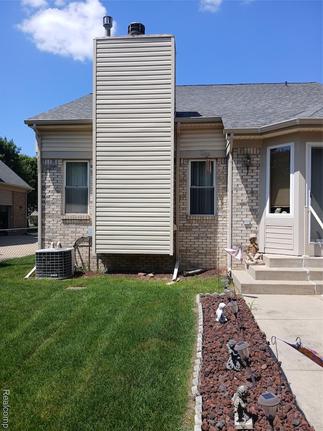 8086 Pickering Pl, Westland, MI 48185 - view of side of home with entry steps, a shingled roof, and brick siding