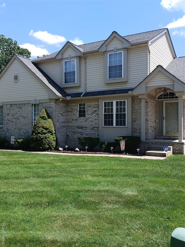 8086 Pickering Pl, Westland, MI 48185 - view of front facade featuring brick siding, a front yard, and a shingled roof