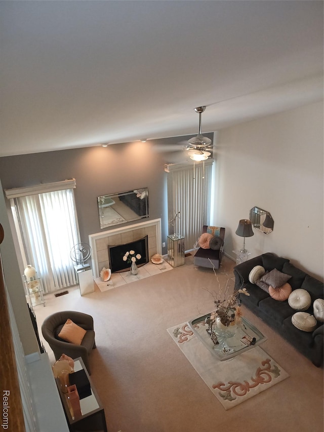 8086 Pickering Pl, Westland, MI 48185 - carpeted living room with a tiled fireplace and ceiling fan