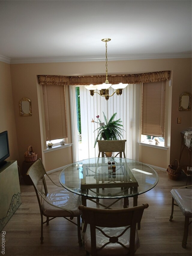 8086 Pickering Pl, Westland, MI 48185 - dining space featuring a chandelier, ornamental molding, and light wood finished floors