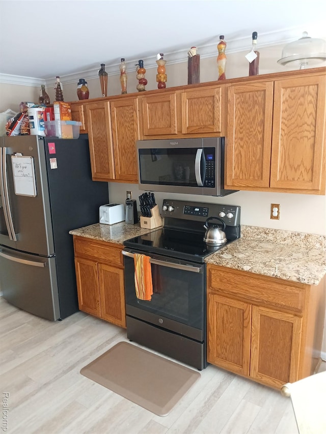 8086 Pickering Pl, Westland, MI 48185 - kitchen featuring stainless steel appliances, light wood-type flooring, ornamental molding, light stone counters, and brown cabinetry