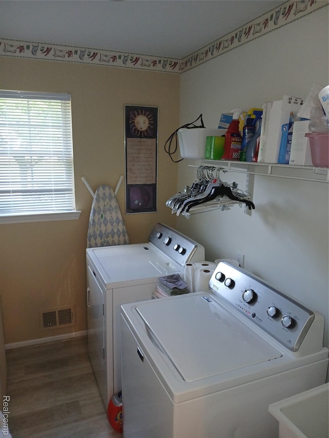 8086 Pickering Pl, Westland, MI 48185 - laundry area with washing machine and clothes dryer and light wood-type flooring