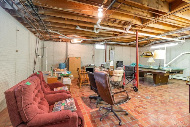 5772 Greensboro Way, Gladwin, MI 48624 - basement featuring billiards table, brick wall, brick patterned flooring, and a baseboard heating unit