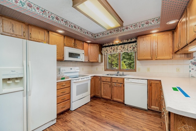 5772 Greensboro Way, Gladwin, MI 48624 - kitchen with white appliances, backsplash, light wood finished floors, light countertops, and recessed lighting