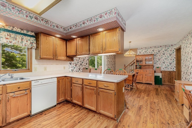5772 Greensboro Way, Gladwin, MI 48624 - kitchen with dishwasher, wallpapered walls, a peninsula, light wood-style flooring, and light countertops