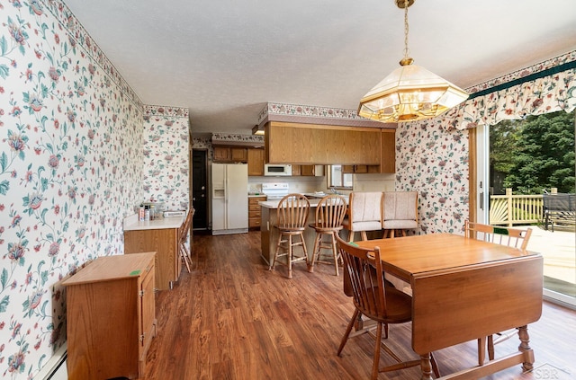 5772 Greensboro Way, Gladwin, MI 48624 - dining space featuring wallpapered walls, a chandelier, dark wood finished floors, and a textured ceiling