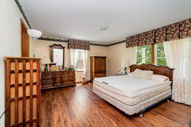 5772 Greensboro Way, Gladwin, MI 48624 - bedroom with dark wood finished floors and baseboards