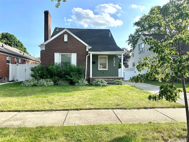 20979 Audette St, Dearborn, MI 48124 - view of front of property featuring board and batten siding, a gate, a chimney, brick siding, and covered porch