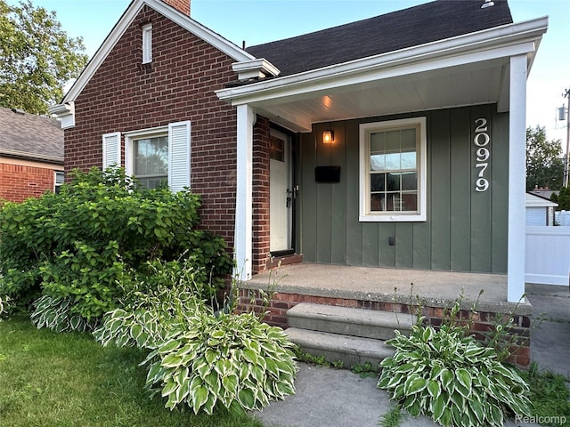 20979 Audette St, Dearborn, MI 48124 - view of front of home with brick siding, a chimney, board and batten siding, and roof with shingles
