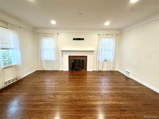 20979 Audette St, Dearborn, MI 48124 - unfurnished living room featuring a brick fireplace, crown molding, dark wood-style floors, and recessed lighting